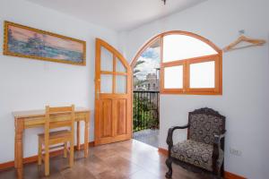 a room with a table and a chair and a door at Casa Munayki in Ayacucho +57 photos