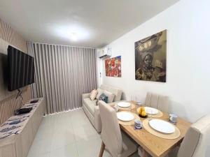 a living room with a table and a couch at Team Renacer Broker Brisas del Mar and Pool in Cartagena de Indias