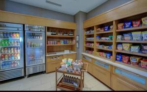 a grocery store aisle with a refrigerator and food at Springhill suites by Marriott in Macon +1 photo