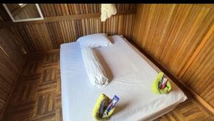 a small bed in a boat with toy cars on it at Rumsram Homestay by Rumah Etnik Papua Sorong in Papermaranda