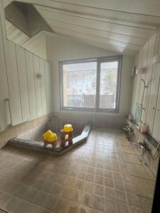 a bathroom with two toilets in a room with a window at Hygge KAWATABI in Osaki