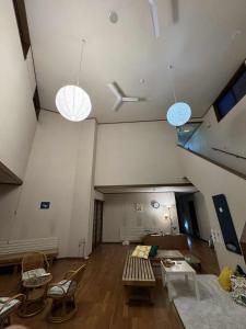 a living room with a couch and chairs and lights at Hygge KAWATABI in Osaki