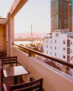a balcony with tables and a view of a city at Silana River Light Hotel in Danang +12 photos