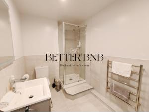 a white bathroom with a shower and a sink at CBD Gem Cooling Summer and City View in Wellington