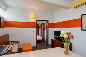 金边Downtime Hotel Phnom Penh的桌子上放着花瓶的房间