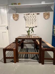 a wooden table and bench in a room at Chalé Praia Doce in Belém