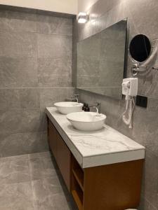 a bathroom with two sinks and a mirror at Hotel Casa Vivaldi in Mérida