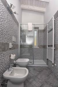 a bathroom with a toilet and a sink and a shower at Apartments in Tremosine sul Garda 34645 in Tremosine Sul Garda