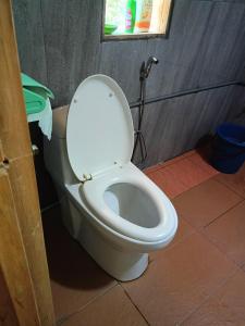 a toilet with the lid up in a bathroom at Bulan And Daud Homestay in Bario +20 photos