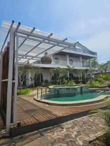 a swimming pool in front of a building at BBC Suites and Garden in Uluwatu