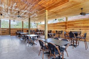 a dining room with tables and chairs and wooden walls at The Angler Hotel Livingston, an Ascend Collection Hotel in Livingston