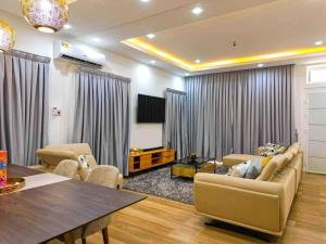 a living room with a couch and a table at Modern Serene 7-Guest Townhome in Trofwi