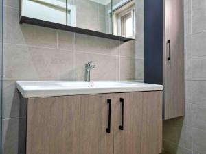 a bathroom with a sink and a mirror at Modern Serene 7-Guest Townhome in Trofwi +56 photos