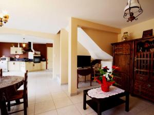 a kitchen and living room with a table and a dining room at Gîte en Pierre avec Grand Terrain à Saint-Nizier-de-Fornas - FR-1-496-259 in Saint-Nizier-de-Fornas