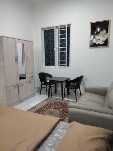 a living room with a couch and a table at Makwan Homestay D in Kubang Semang