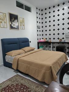 Ένα ή περισσότερα κρεβάτια σε δωμάτιο στο Makwan Homestay D