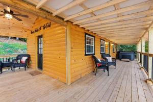 a wooden deck with chairs and a ceiling at Throw'n Shade at the Red - near RRG KY in Stanton