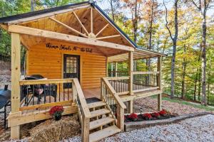 a log cabin with a staircase leading to a deck at Throw'n Shade at the Red - near RRG KY in Stanton