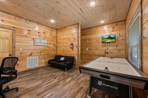 a room with a ping pong table in a cabin at Pet-Friendly Sevierville Cabin, Hot Tub, Air Hock in Sevierville