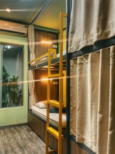 a bunk bed in a room with a ladder at Hanoi Quarter Life Hostel in Hanoi