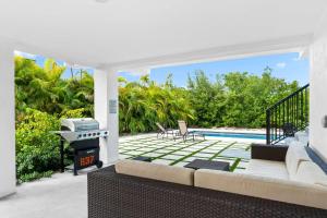 マラソンにあるIsla Luna Waterfront Oasis Pool Dock Kayaksのグリルとプールを備えた屋外リビングルーム +45枚の写真