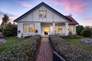 a white house with a brick driveway at Talina - History in the Heart of St Helens in St Helens