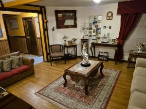 a living room with a couch and a coffee table at Hostal Oasis in Puerto Natales