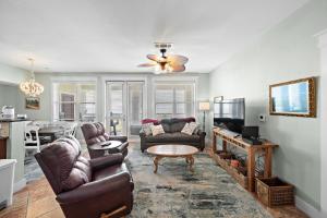 a living room with a couch and a table at Pointe West 302 - Sunset on the Bay in Galveston
