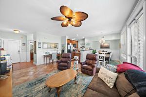 a living room with a couch and a table at Pointe West 302 - Sunset on the Bay in Galveston