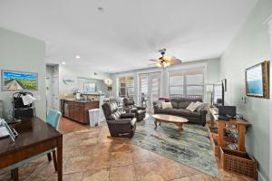 a living room with a couch and a table at Pointe West 302 - Sunset on the Bay in Galveston
