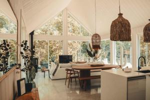 a kitchen and living room with a table and chairs at Zen House 7 - Villas & Spa in Morin Heights