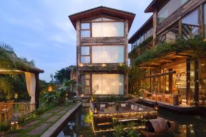 een huis met een hottub in het midden van een vijver bij Meilanmeilv Forest Luxe Inn-Chengdu Sansheng Township Branch in Ta-mien-chen