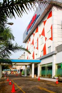 a mobil gas station with orange cones in front of it at Hotel Marlin Pekalongan in Pekalongan