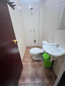 a bathroom with a toilet and a sink at Curahuasi Backpackers in Curahuasi