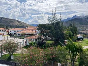 a small village with houses and mountains in the background at Curahuasi Backpackers in Curahuasi