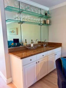 a bathroom with a sink and a mirror at Welcoming 2-bedroom condo with bonus room! in Indian Shores +6 photos