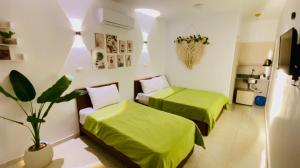 a bedroom with two beds and a potted plant at Shark house dahab in Dahab
