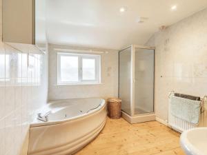 a white bathroom with a tub and a sink at 3 Bed in Portinscale SZ335 in Portinscale +34 photos