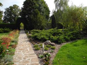 a garden with a stone path and plants at Apartments in Vetschau Spreewald 2618 in Vetschau +9 photos