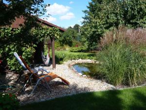 a garden with a bike parked next to a pond at Apartments in Vetschau Spreewald 2618 in Vetschau
