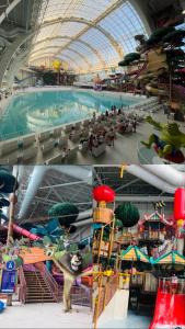 a large indoor water park with a swimming pool at Cozy Retreat Near EWR with NYC access in Newark