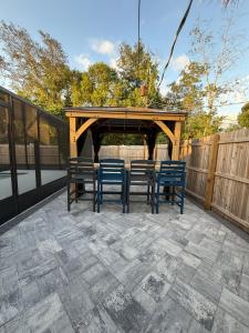 a patio with four chairs and a gazebo at Serene Sunshine State Escape in Deltona