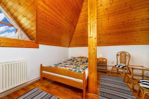 a bedroom with a bed and a wooden ceiling at Holiday home Balatonbereny - Balaton 18099 in Part
