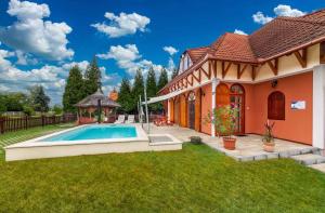 a house with a swimming pool in the yard at Holiday home Balatonbereny - Balaton 18099 in Part