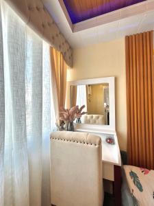 een kleedkamer met een stoel en een spiegel bij J&J Havenstay Ananda Square in Manilla