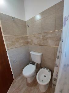 a small bathroom with a toilet and a bidet at Bosquemolinos in Villa Los Molinos