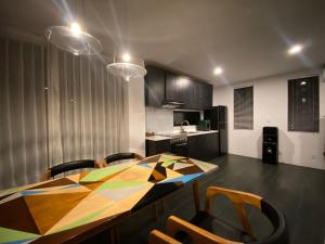 a kitchen with a table and chairs in a room at Asri loka villa in Ubud