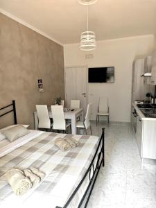 a bedroom with a bed and a table with chairs at Da Nonno Mario in Bagnoli Irpino