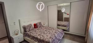 a small bedroom with a bed and a mirror at Modern & Comfortable Apartment in Aouina in El Aouina Station