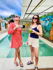 two women standing next to a swimming pool at Maya Dreams Bacalar in Bacalar